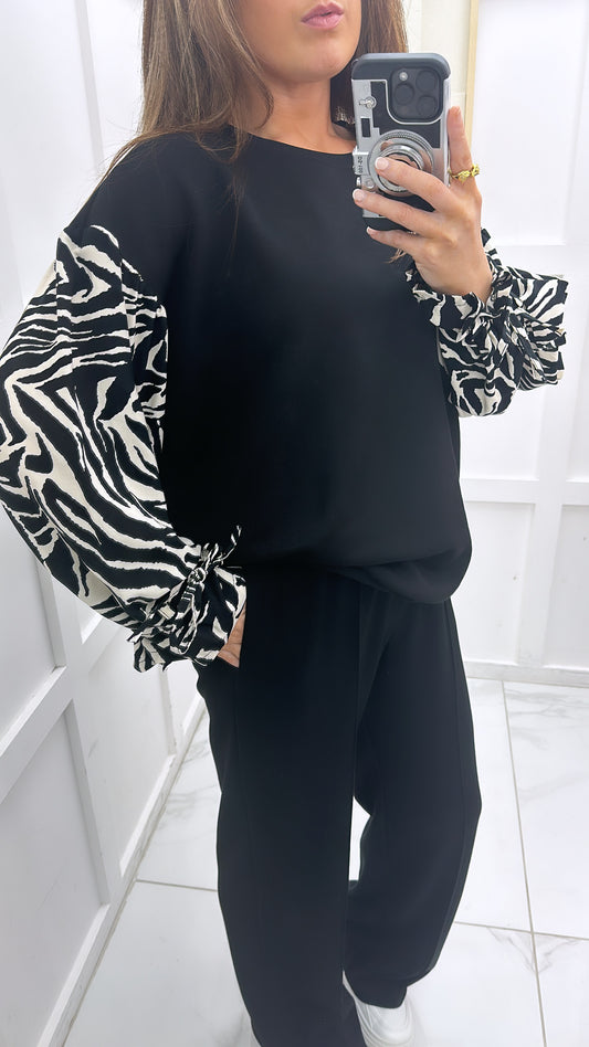 ESME black sweatshirt with zebra print sleeves