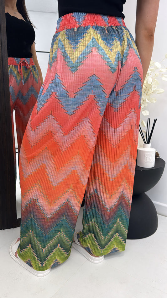 ARIEL orange pleated printed palazzo trousers