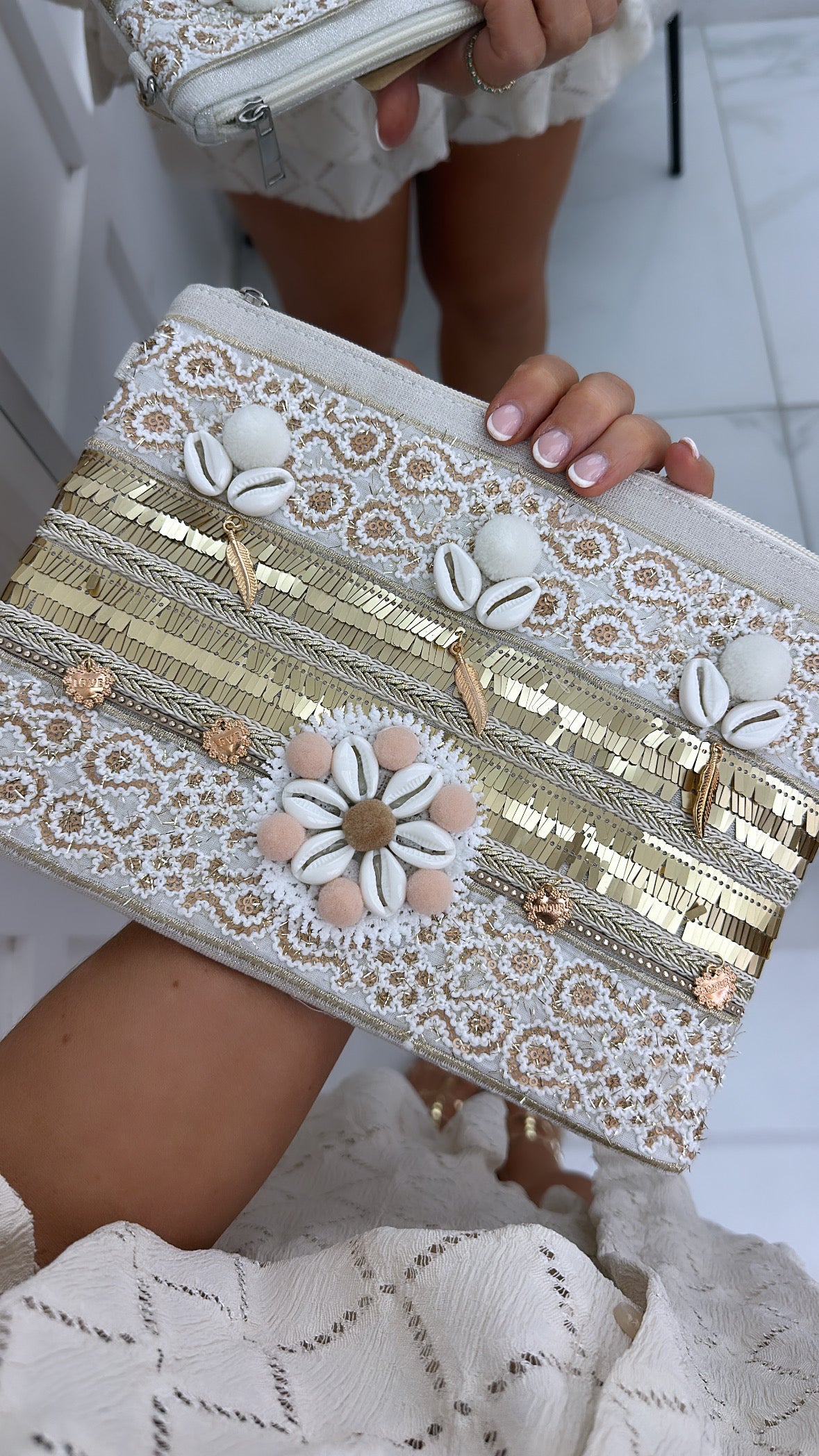 ARIA cream pompom & shell detail clutch bag